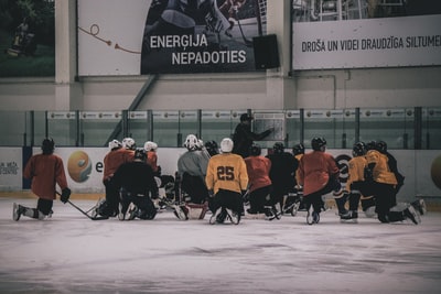 Hockey coach in front of the hockey player
